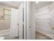 Bathroom with a tub and a separate closet with wire shelving at 9012 Saint Thomas Ln, Charlotte, NC 28277