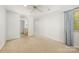 Spacious bedroom with neutral carpeting, a ceiling fan, and an ensuite bathroom at 9012 Saint Thomas Ln, Charlotte, NC 28277