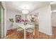 Bright dining area with hardwood floors, modern lighting, and a view of the kitchen, designed for entertaining at 9012 Saint Thomas Ln, Charlotte, NC 28277