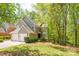 Charming home with a two-car garage, lush landscaping, and a tranquil, tree-filled backyard at 9012 Saint Thomas Ln, Charlotte, NC 28277