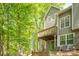 Exterior view of a home with a wooden deck, siding, and a landscaped backyard at 9012 Saint Thomas Ln, Charlotte, NC 28277
