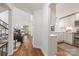 Bright, open hallway with hardwood floors leading to the living room and kitchen, showcasing a modern design at 9012 Saint Thomas Ln, Charlotte, NC 28277