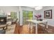 Cozy dining area featuring hardwood floors, a fireplace, and views of the deck through a large sliding glass door at 9012 Saint Thomas Ln, Charlotte, NC 28277
