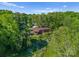 Aerial view of a brick home surrounded by mature trees and landscaping at 916 E Park Dr, Lincolnton, NC 28092
