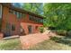 Brick home featuring a brick patio and mature trees at 916 E Park Dr, Lincolnton, NC 28092