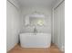 Elegant bathroom featuring a modern soaking tub, an ornate mirror, and bright lighting at 916 E Park Dr, Lincolnton, NC 28092
