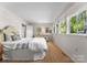Bright bedroom featuring wood floors and lots of natural light from multiple windows with white window treatments at 916 E Park Dr, Lincolnton, NC 28092