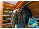 Wooden walk-in closet with fur coats and shelved compartments offering additional storage for shoes and accessories at 916 E Park Dr, Lincolnton, NC 28092