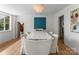 Elegant dining room with a marble top table, chandelier, and lots of light from the window at 916 E Park Dr, Lincolnton, NC 28092