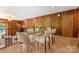 The light-filled dining room features a large picture window, wood paneling, and chandelier at 916 E Park Dr, Lincolnton, NC 28092