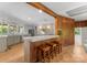 Open-concept kitchen and bar with white cabinets and a breakfast bar at 916 E Park Dr, Lincolnton, NC 28092