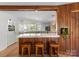 Bright eat-in kitchen features wood paneling, breakfast bar with seating, and many windows to the backyard at 916 E Park Dr, Lincolnton, NC 28092