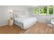 Comfortable main bedroom featuring a bed, side table, and bright windows for lots of natural light at 916 E Park Dr, Lincolnton, NC 28092