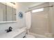 Clean bathroom with a shower/tub combo, white fixtures, and neutral decor at 1002 Christobal Ct, Indian Trail, NC 28079