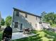 Rear exterior view with an outdoor patio and well-maintained lawn at 1033 Lilly Pond Dr, Fort Mill, SC 29715