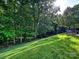 Beautifully landscaped backyard with lush green grass and mature trees at 1033 Lilly Pond Dr, Fort Mill, SC 29715