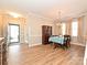 Formal dining room with wood floors, elegant lighting, and access to the entryway at 1033 Lilly Pond Dr, Fort Mill, SC 29715