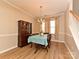 Formal dining room with wood floors, elegant lighting, and access to the staircase at 1033 Lilly Pond Dr, Fort Mill, SC 29715