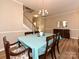 Dining room with wood floors, neutral colors, and a charming chandelier at 1033 Lilly Pond Dr, Fort Mill, SC 29715