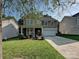Beautiful home with manicured lawn, a two-car garage and inviting front porch at 1033 Lilly Pond Dr, Fort Mill, SC 29715