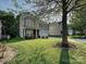 Two-story home featuring manicured front lawn, a covered porch, and a two-car garage at 1033 Lilly Pond Dr, Fort Mill, SC 29715