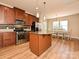 Well-equipped kitchen features stainless appliances, granite island and counters, and an adjacent dining area at 1033 Lilly Pond Dr, Fort Mill, SC 29715