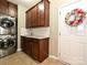 Functional laundry room offers a sink, granite counters, subway tile backsplash, and a stacked washer/dryer at 1033 Lilly Pond Dr, Fort Mill, SC 29715
