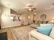 Open-concept living room with wood floors, a ceiling fan, and ample seating at 1033 Lilly Pond Dr, Fort Mill, SC 29715