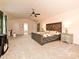 Spacious primary suite with natural light, a ceiling fan, and a neutral carpet at 1033 Lilly Pond Dr, Fort Mill, SC 29715