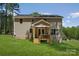 Exterior view of the home showcasing the backyard, deck and lawn at 1112 Allman Ext, Mount Pleasant, NC 28124