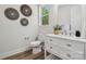 Bright bathroom featuring a sleek white vanity, elegant decor, and stylish wood-look flooring at 1112 Allman Ext, Mount Pleasant, NC 28124