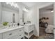 Bathroom featuring double vanity with framed mirrors, wood-look floors and an open doorway to bedroom at 1112 Allman Ext, Mount Pleasant, NC 28124