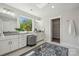 Bright bathroom offers a double vanity, makeup counter, and large window with a serene outdoor view at 1112 Allman Ext, Mount Pleasant, NC 28124