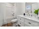 Bright bathroom with a shower-tub combo, a white vanity with marble countertop, and wood-style vinyl flooring at 1112 Allman Ext, Mount Pleasant, NC 28124