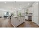 Open kitchen with white cabinetry, an island, stainless steel appliances, and hardwood floors at 1112 Allman Ext, Mount Pleasant, NC 28124