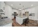 Spacious kitchen with granite countertops, white cabinetry, a center island, and stainless steel appliances at 1112 Allman Ext, Mount Pleasant, NC 28124