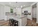 Modern kitchen with white cabinets, granite countertops, stainless steel appliances, and a center island at 1112 Allman Ext, Mount Pleasant, NC 28124