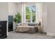 Stylish living area with a comfortable sofa, side table, and a large window with backyard view at 1112 Allman Ext, Mount Pleasant, NC 28124