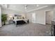 Spacious main bedroom features soft carpet, tray ceiling, and a view into the en suite bathroom at 1112 Allman Ext, Mount Pleasant, NC 28124