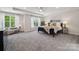 Spacious main bedroom boasts tray ceiling, plush carpet, with large windows offering serene views at 1112 Allman Ext, Mount Pleasant, NC 28124