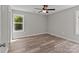 Unfurnished bedroom with new floors, a modern ceiling fan, and natural light from two windows at 112 Cleveland Ave, Albemarle, NC 28001