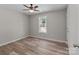 Bedroom showcases a window with natural light, neutral walls, and wood-look flooring at 112 Cleveland Ave, Albemarle, NC 28001
