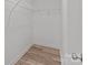 Walk-in closet featuring neutral walls, laminate flooring, and practical wire shelving at 112 Cleveland Ave, Albemarle, NC 28001