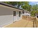 Bright and airy wooden deck with white siding, offering views of the home's surroundings at 112 Cleveland Ave, Albemarle, NC 28001