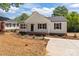 Charming single-story home with symmetrical windows, black shutters, and inviting front porch at 112 Cleveland Ave, Albemarle, NC 28001