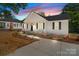 Charming one-story home with white siding, black shutters, and a cozy front porch at 112 Cleveland Ave, Albemarle, NC 28001