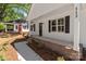 Charming one-story home with white siding, black shutters, and a cozy front porch at 112 Cleveland Ave, Albemarle, NC 28001