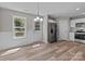Bright open kitchen with modern appliances, a stylish chandelier, and light wood-look floors at 112 Cleveland Ave, Albemarle, NC 28001