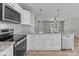Kitchen with white cabinets, granite countertops, stainless steel appliances, and subway tile backsplash at 112 Cleveland Ave, Albemarle, NC 28001