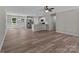 Open-concept living space with luxury vinyl plank flooring and a modern kitchen at 112 Cleveland Ave, Albemarle, NC 28001
